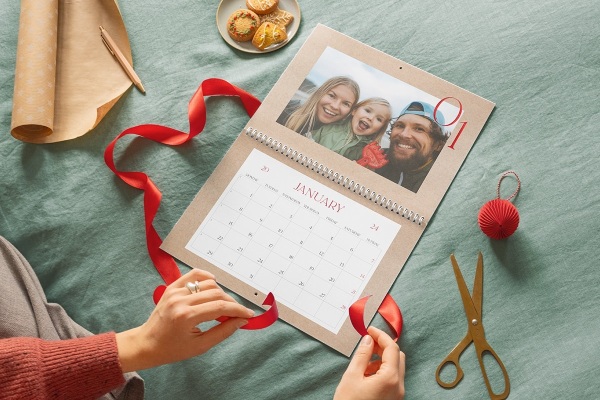 woman wrapping up personalised large calendar as a gift