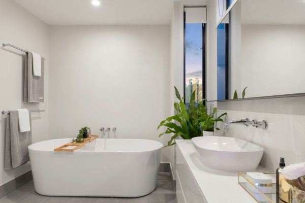 bathroom with 1500mm freestanding bathtub, vanity, mirror, towels, plant